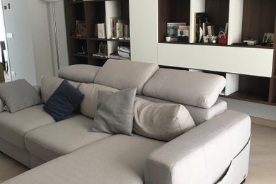 Ispirazione per un grande soggiorno minimalista aperto con libreria, pavimento in gres porcellanato, parete attrezzata, pareti bianche e pavimento marrone