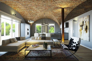Esempio di un soggiorno industriale di medie dimensioni e stile loft con pareti grigie, parquet chiaro e parete attrezzata