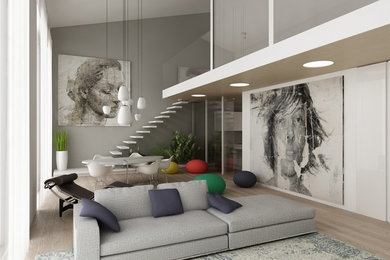 Esempio di un grande soggiorno moderno stile loft con parquet chiaro e TV a parete