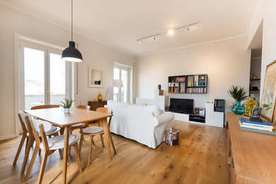 Mid-sized danish open concept light wood floor living room photo in Rome with gray walls and a tv stand