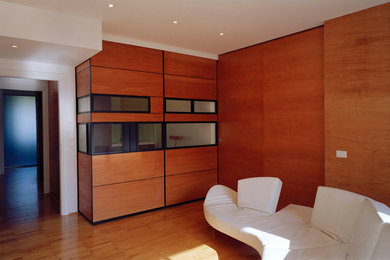 Medium sized contemporary enclosed games room in Rome with medium hardwood flooring and brown floors.