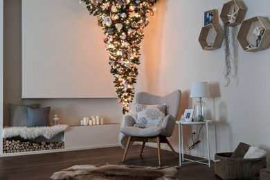 Diseño de sala de estar abierta escandinava grande sin televisor con paredes blancas, suelo de madera oscura, chimenea lineal, marco de chimenea de yeso y suelo marrón