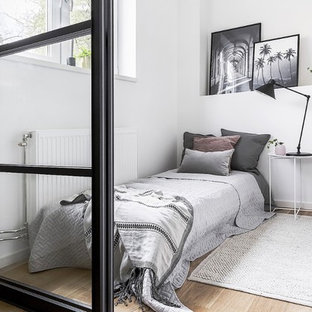 Inspiration för minimalistiska sovrum, med vita väggar, ljust trägolv och beiget golv