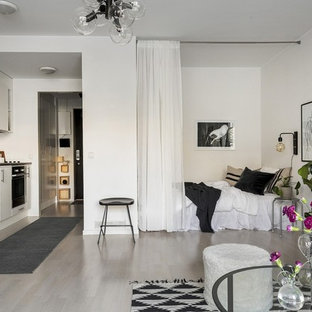 Inspiration för skandinaviska sovrum, med vita väggar och grått golv
