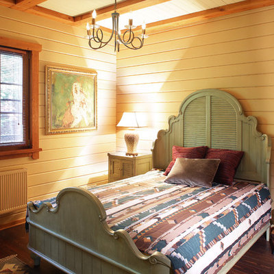 Example of a mid-sized country guest dark wood floor and brown floor bedroom design in Moscow with beige walls