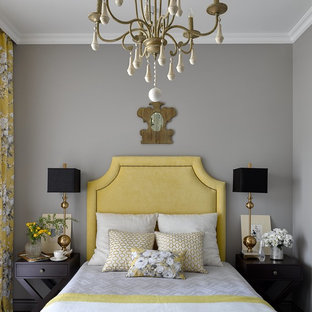 Idée de décoration pour une petit chambre d'amis tradition avec un mur gris.