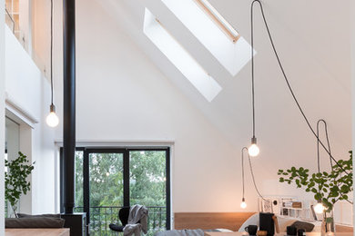 Example of a trendy master medium tone wood floor and beige floor bedroom design in Moscow with white walls, a wood stove and a metal fireplace