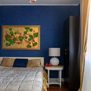 Modelo de dormitorio principal, clásico renovado, pequeño, con paredes azules, suelo laminado y suelo marrón