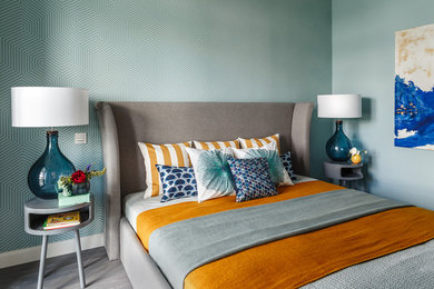 This is an example of a small classic master bedroom in Moscow with medium hardwood flooring, grey floors and blue walls.