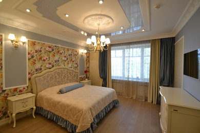 Classic master bedroom in Other with multi-coloured walls, medium hardwood flooring and brown floors.