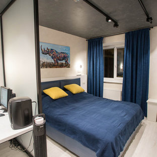 Imagen de dormitorio principal, industrial, de tamaño medio, sin chimenea, con paredes blancas, suelo vinílico y suelo gris