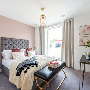 This is an example of a contemporary grey and pink bedroom in London with pink walls, carpet and grey floors.