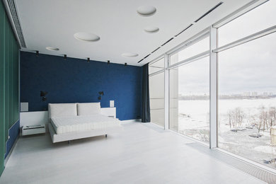 Expansive contemporary master bedroom in Moscow with blue walls.
