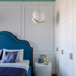 Eclectic master bedroom with white walls, dark hardwood floors and brown floor.