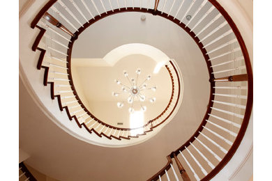 Staircase - traditional wooden curved staircase idea in Richmond with wooden risers