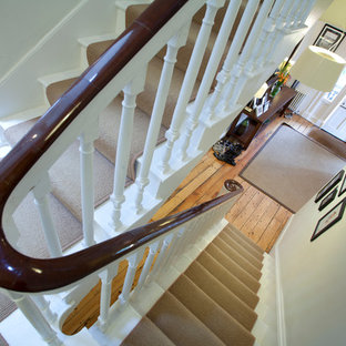 This is an example of a large victorian painted wood u-shaped staircase in London with painted wood risers.