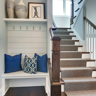 Classic wood u-shaped staircase in Minneapolis with painted wood risers.