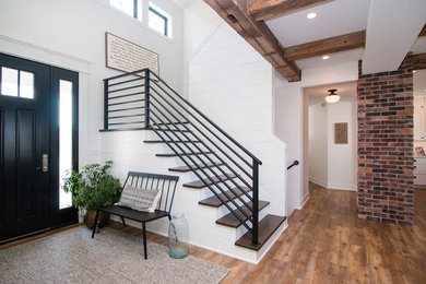Example of a mid-sized farmhouse wooden l-shaped metal railing staircase design in Other with painted risers