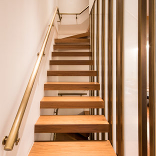 Trendy wooden l-shaped open and metal railing staircase photo in New York