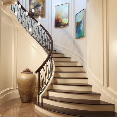 Transitional wooden curved mixed material railing staircase photo in Miami with painted risers