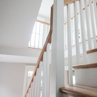 Exemple d'un grand escalier romantique en L avec des contremarches en bois, des marches en bois et un garde-corps en bois.