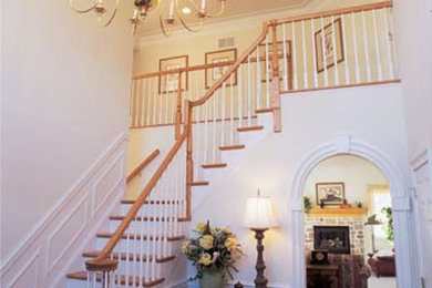 Mid-sized elegant wooden l-shaped wood railing staircase photo in Atlanta with painted risers