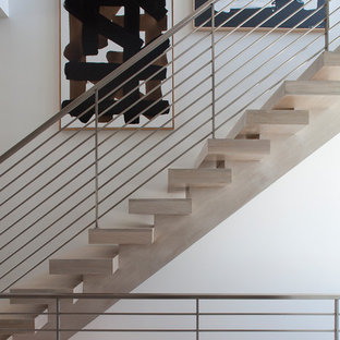 Inspiration for a mid-sized contemporary wooden floating open and metal railing staircase remodel in Other