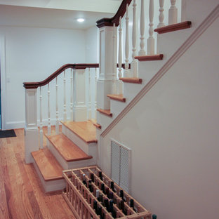 Imagen de escalera en U, de estilo americano, de tamaño medio, con escalones de madera, contrahuellas de madera y barandilla de madera