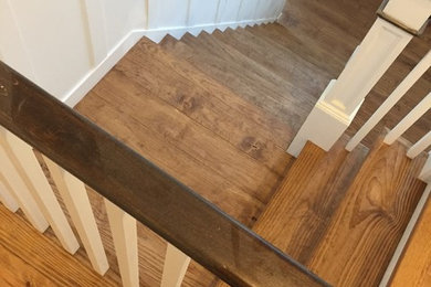 Photo of a medium sized rustic wood l-shaped staircase in New York with painted wood risers.