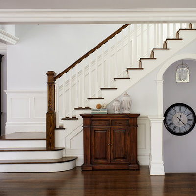Example of a mid-sized classic wooden l-shaped staircase design in New York with painted risers