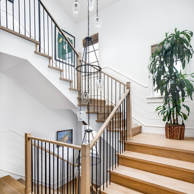 Staircase - coastal wooden u-shaped mixed material railing staircase idea in Los Angeles with wooden risers