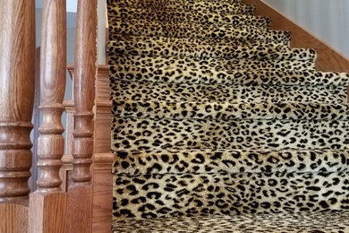This is an example of a carpeted straight wood railing staircase in Other with wood risers.