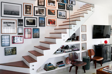 Contemporary wood straight staircase in Other with painted wood risers and under stair storage.