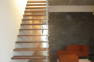 Example of a large trendy wooden floating open staircase design in Chicago
