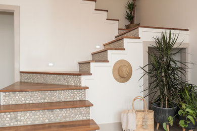 Beach style wooden l-shaped staircase photo in San Francisco with tile risers