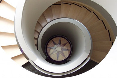 Example of a large trendy wooden spiral staircase design in Edmonton with wooden risers