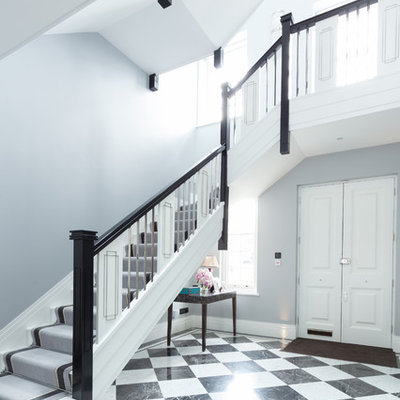 Inspiration for a timeless painted l-shaped staircase remodel in London with painted risers