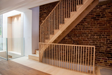 Inspiration for a victorian wood u-shaped wood railing staircase in Other with wood risers.