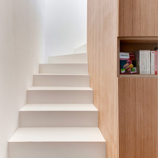 Réalisation d'un grand escalier courbe design avec des marches en béton.