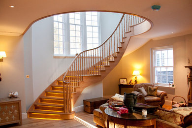 Photo of a country staircase in Other with under stair storage and feature lighting.