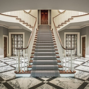 Photo of a medium sized classic carpeted wood railing staircase in Surrey with carpeted risers.