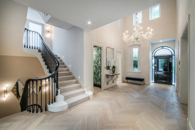 Large traditional curved metal railing staircase in London.