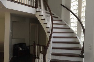 Staircase - mid-sized traditional wooden curved staircase idea in Other with painted risers