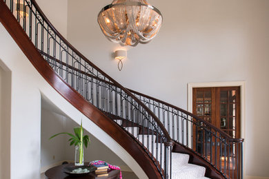 Staircase - large transitional wooden curved staircase idea in Austin with wooden risers