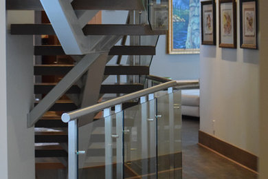 Inspiration for a modern wooden staircase remodel in Calgary