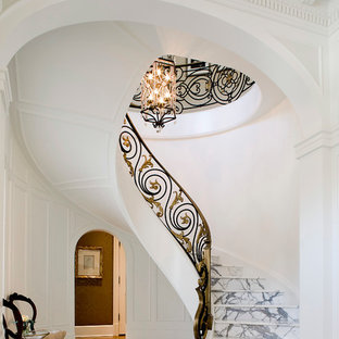 Immagine di una grande scala sospesa chic con pedata in marmo e alzata in marmo
