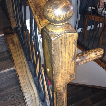 BENT iron design interior railing with a distressed wood handrail and base