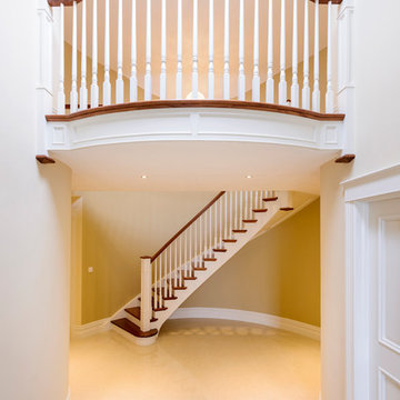 Bespoke curved cut-string staircase with Juliet balcony