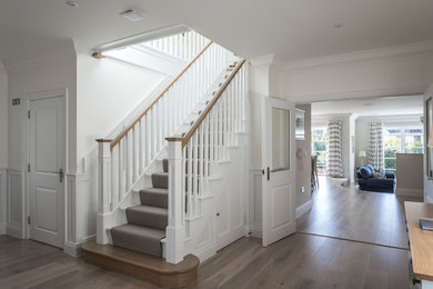 This is an example of a traditional wood straight wood railing staircase in Dorset with wood risers.