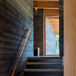 Inspiration for a mid-sized rustic wooden straight staircase remodel in Seattle with metal risers